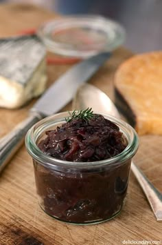 a glass jar filled with food sitting on top of a wooden cutting board