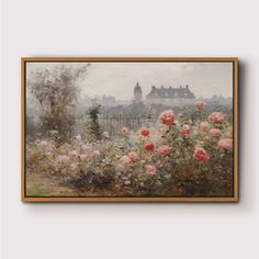 a painting hanging on the wall in front of a white wall with flowers and buildings