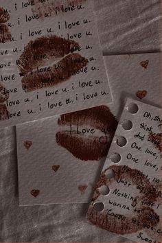 three pieces of paper with writing on them and two lipstick imprints in the middle