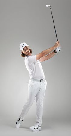 a man holding a golf club in his right hand