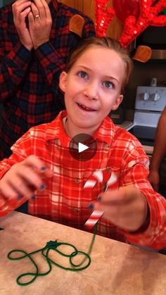 a young boy is making christmas decorations with scissors