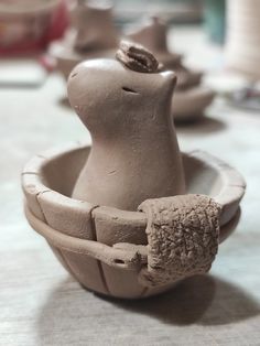 some clay animals are sitting in a bowl