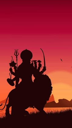 the silhouette of a man riding on top of a horse in front of a sunset