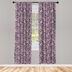 a window with purple curtains and wooden floors