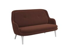 a brown couch sitting on top of a white floor next to a metal legrest