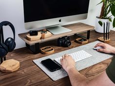 a man sitting at a desk using a mouse pad to type on his computer keyboard