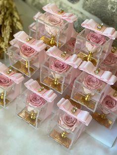 many small boxes with pink roses in them