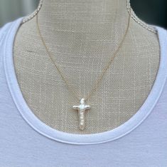 "Beautiful fresh water cross pearl on a 14K gold filled or sterling silver chain.  Chain pictured is approximately 17\" and a nice texture and weight.  Cross measures approximately 1.5\" x 1\".   Each pearl cross is unique and will not look exactly as pictured, as they are uniquely different AAA quality pearls.  I hand drill the pieces myself. Please note that each pearl cross is individually unique in shape.  If you prefer a small, large, or chunky cross, please indicate it on the order in the White Cross Necklace With Pearl Pendant, Pearl Chain Cross Pendant Necklace Gift, Gift Pearl Chain Cross Pendant Necklace, Pearl Chain Cross Necklace Gift, Gold Cross Necklace With Pearl Chain, Pearl Chain Cross Necklace As Gift, White Cross Necklace With Pearl Charm, Gold Cross Necklace With Pearl Pendant, Pearl Drop Cross Pendant Necklace