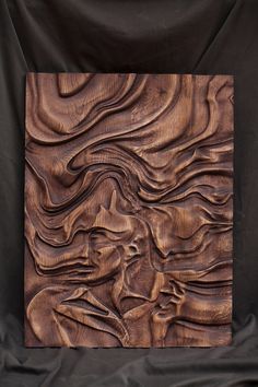 a wooden sculpture is shown on a black background