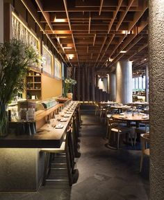 an empty restaurant with wooden tables and chairs