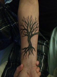 a person with a tree tattoo on their arm