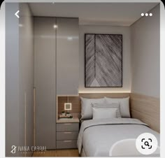 a bed sitting next to a closet in a bedroom under a painting on the wall