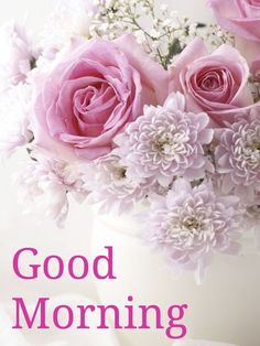 a vase filled with pink flowers sitting on top of a white table next to the words happy sunday good morning