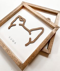 two wooden frames with the shape of a horse's head and name on them