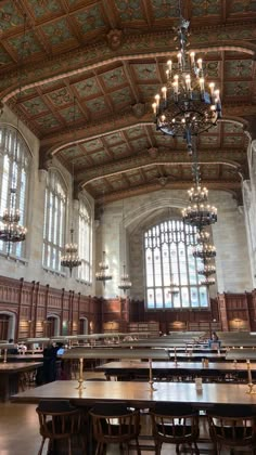 a large room with tables and chandeliers in it