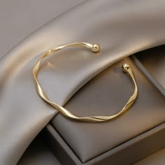 Discover the stunning Gigi Wavy Gold Bracelet from Valentina & Rose. This exquisite piece is crafted from high-quality 14K gold and features a unique wavy design that adds a touch of elegance to any outfit. With its adjustable size, this bracelet can be comfortably worn by women of all wrist sizes. Perfect for special occasions or everyday wear, the Gigi Wavy Gold Bracelet is a must-have accessory that will elevate your style. This gorgeous bracelet is designed to stand the test of time, with it Adjustable Bangle Bracelet With Simple Design, Modern Twist Bangle As Gift, Elegant Adjustable Metal Cuff Bracelet, Adjustable Modern Twist Bangle, Elegant Adjustable Cuff Bracelet For Everyday, Elegant Everyday Adjustable Cuff Bracelet, Adjustable Dainty Bangle For Formal Occasions, Elegant Bangle With Simple Design, Metal Cuff Bracelet