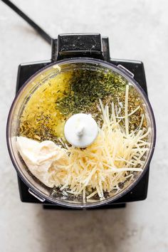 a food processor filled with cheese and other ingredients