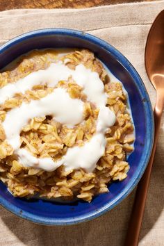 a blue bowl filled with oatmeal sitting on top of a table