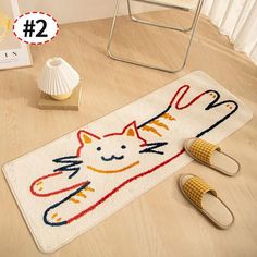 a pair of slippers sitting on top of a floor next to a cat rug