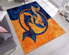 a living room area rug with an orange and blue design