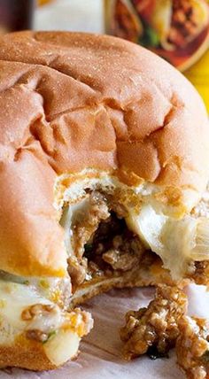 a meatball sandwich cut in half on a cutting board