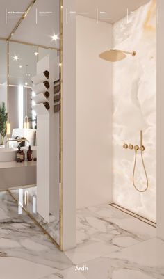 a bathroom with marble flooring and white walls, along with a gold shower head