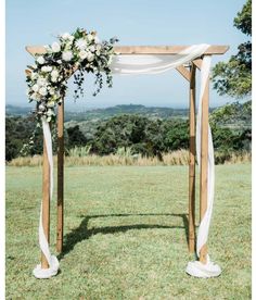 an outdoor wedding setup with white flowers and greenery