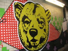 there is a bear painted on the side of a wall with polka dotes and dots