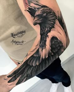 a man's arm with a black and white tattoo of an eagle on it