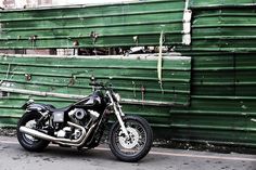 a motorcycle parked in front of a green building