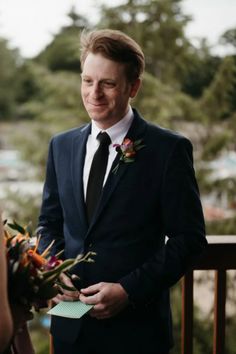 a man in a suit standing next to a woman