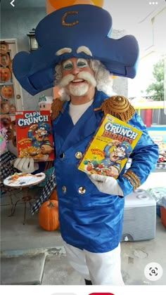 a man in a blue suit and hat holding a box of crayon cereal