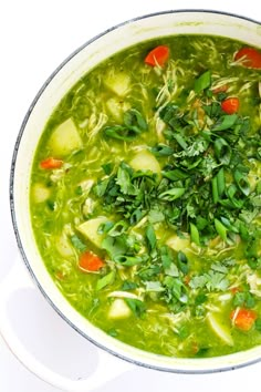 a pot filled with soup and vegetables on top of a table