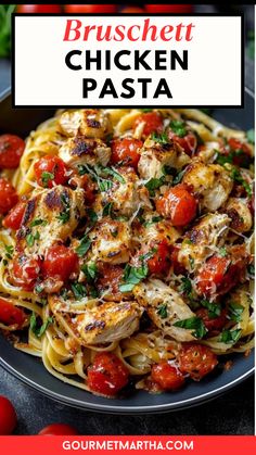 chicken pasta with tomatoes and parmesan cheese in a black plate on a table