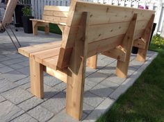 a wooden bench sitting on top of a brick patio