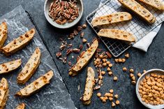 several pieces of bread and some nuts on a table