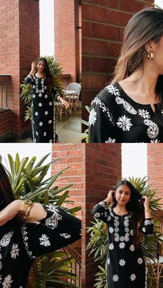 a woman wearing a black and white floral print dress with long sleeves, standing in front of a brick wall