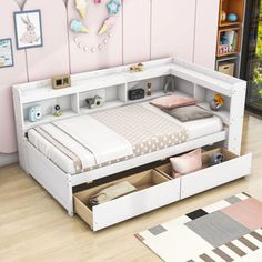 a white bed with drawers underneath it in a pink walled room next to a window