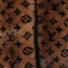 an animal fur coat with the letters louis vuitton on it's side