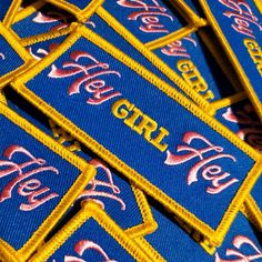 several blue and yellow patches with the words girl on them