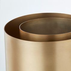 a close up of a gold vase on a white background