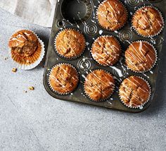 freshly baked muffins sitting in a muffin tin on top of a table