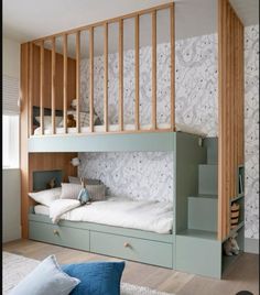 a bedroom with bunk beds and stairs in the wall, next to a bed that's built into the floor