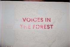 there is a sign on the wall that says voice in the forest and it reads,