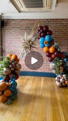 balloons are arranged in the shape of an arch with plants and rocks on it, along with other decorations