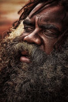 a close up of a man with long hair and beard