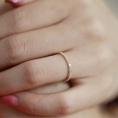 a woman's hand with a diamond ring on it