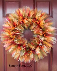 a colorful wreath hanging on the front door