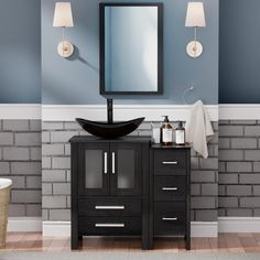 a bathroom vanity with a mirror, sink and towel rack in front of brick wall