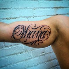 a man's arm with the word tattoo on it